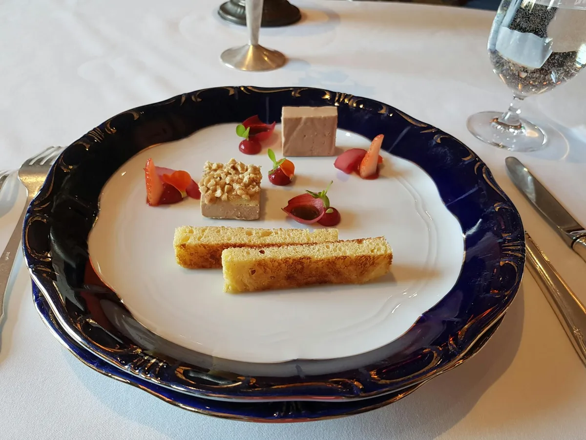 Close-up of gourmet dessert with strawberries and mousse elegantly plated in a Budapest restaurant.